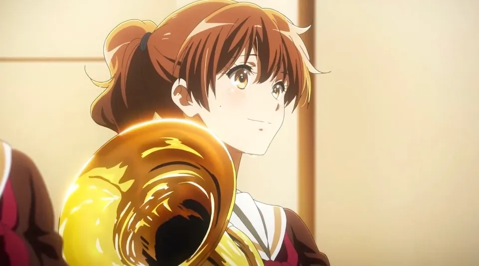 The girl is about to play a trumpet 